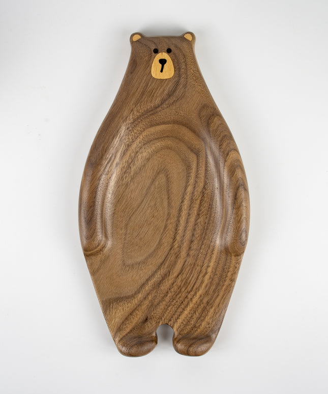 Close-up of cute bear face carved and inlaid on a solid walnut wood tray